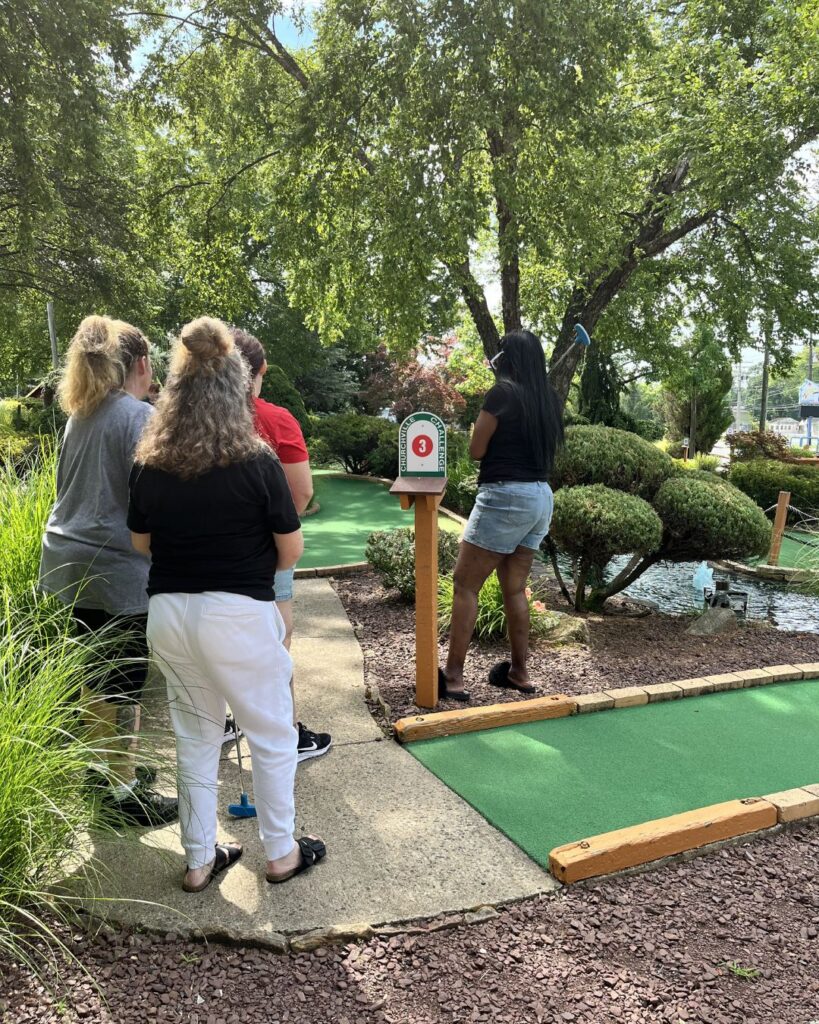 Community recovery mini-golf event invitation.