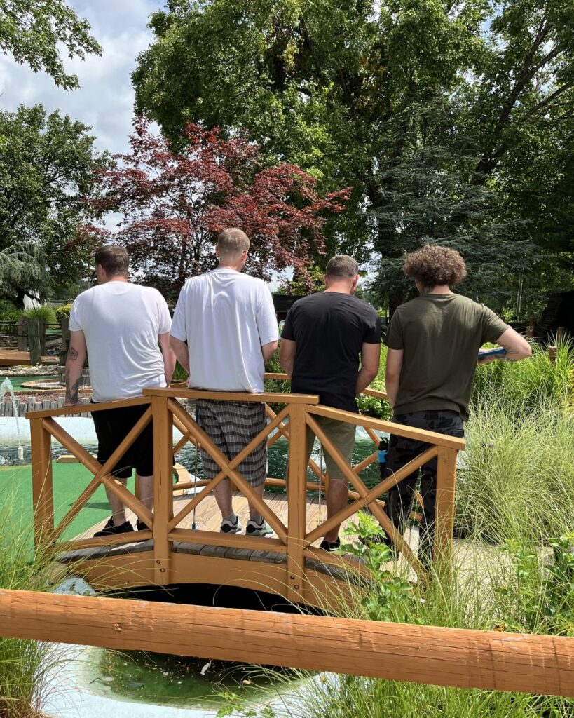 Community recovery mini-golf event invitation.