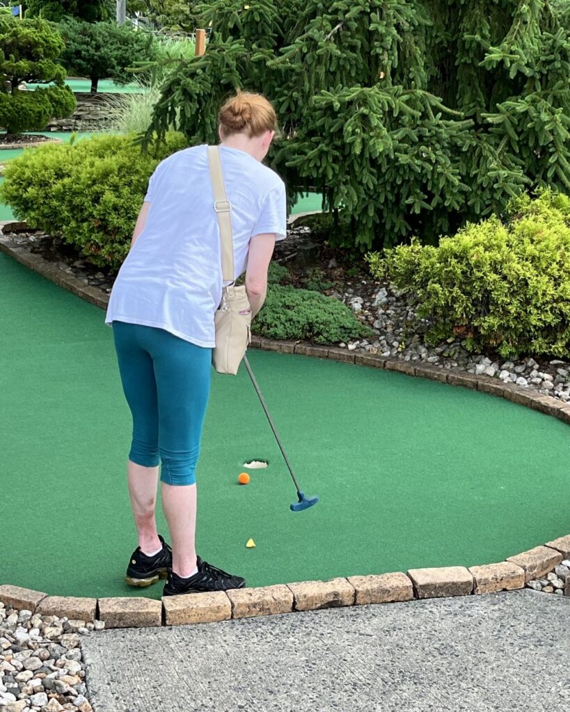 Community recovery mini-golf event invitation.